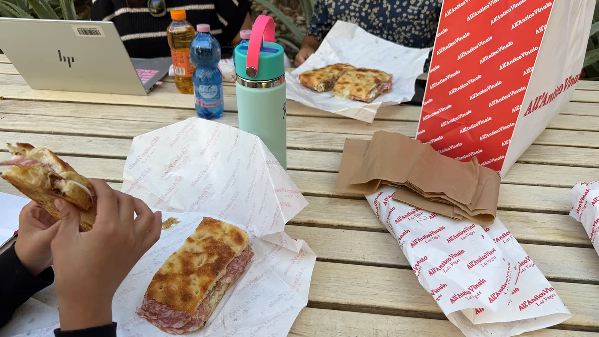 Sandwiches from All'Antico Vinaio at outdoor table.
