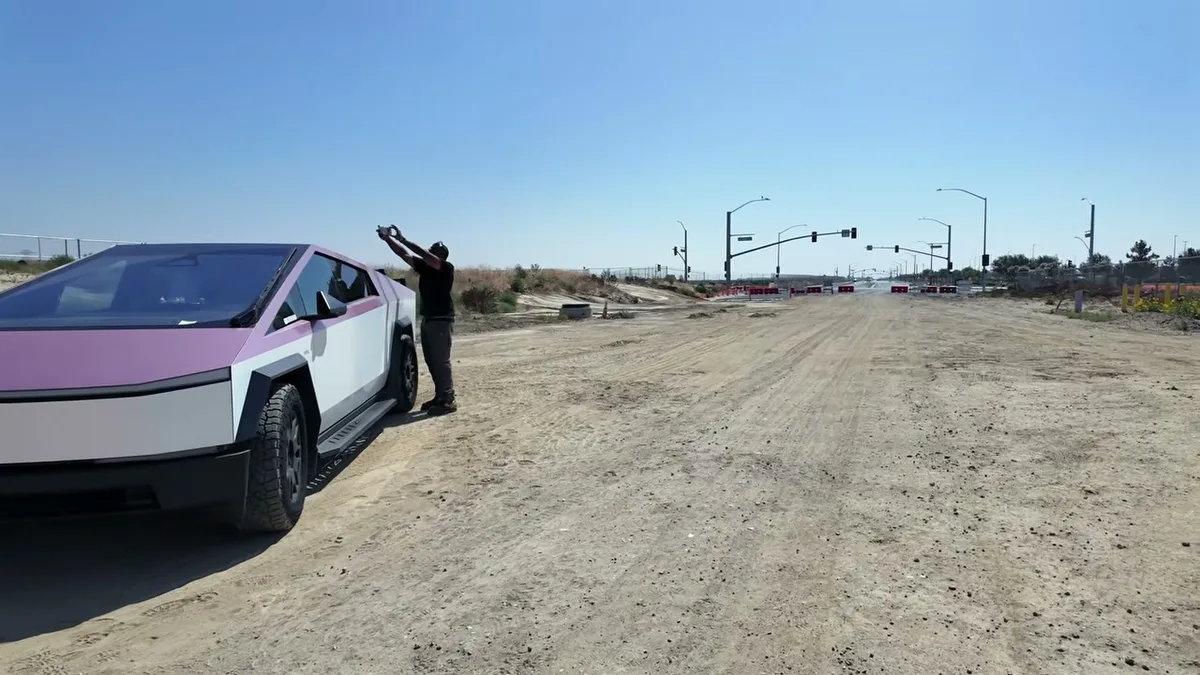 KobraToldYa filming B-roll of the pink-wrapped Cybertruck on a dirt road