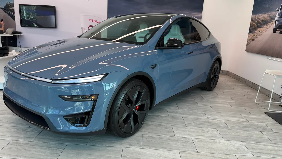 Frost Blue Model Y Performance showing black aero wheels and red brake calipers