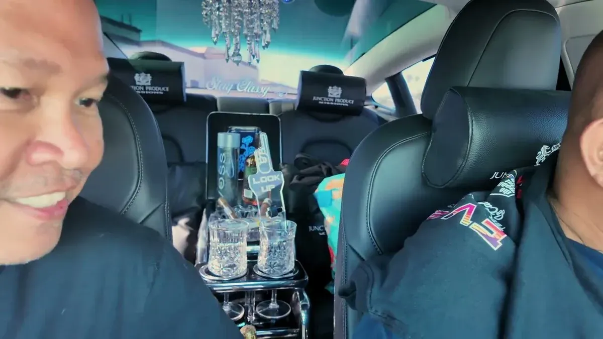 Marvin's 2022 Model 3 bippu interior detail, crystal chandelier and Stay Classy visor at EV Fest 2026