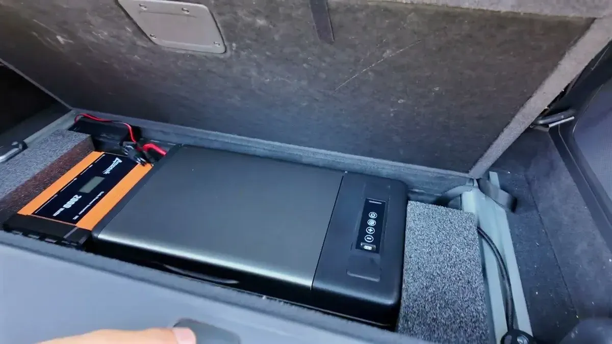 Vehicle rear cargo area with 200W power inverter and compact 18-quart black refrigerator installed