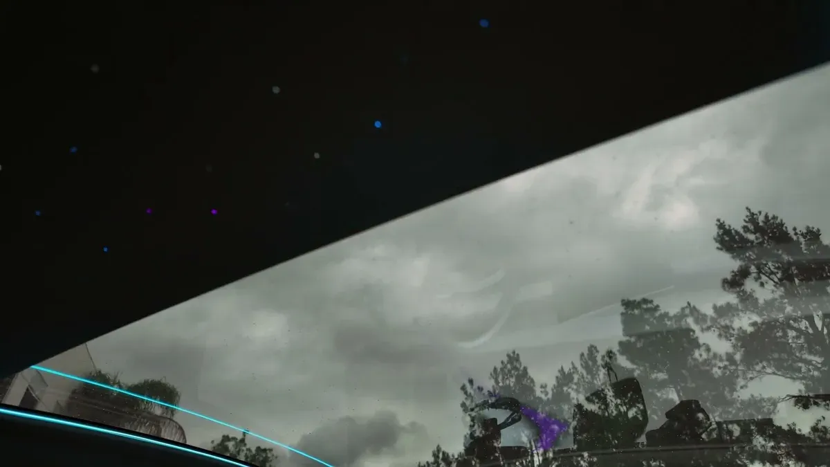 Juniper sunroof closing with starlight LEDs visible against the cloudy sky.