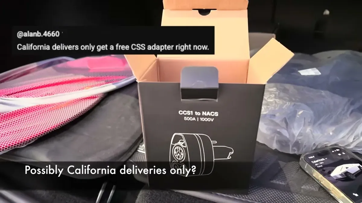 CCS1 to NACS adapter box open to reveal the adapter, placed on the Model Y Juniper center console