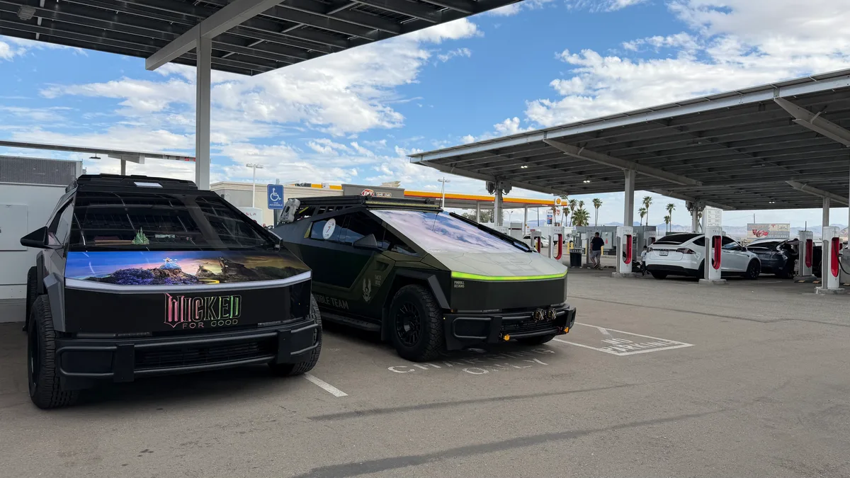 Multiple custom Cybertrucks parked at a Shell EV charging station during the Zero Emissions Run Las Vegas