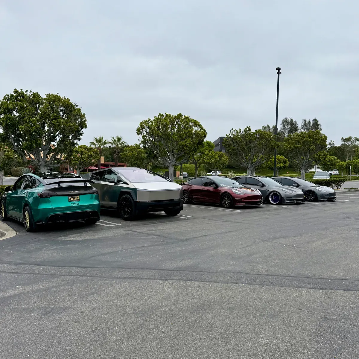 Custom EV lineup including Cybertrucks and modified Teslas at the Electrify Expo venue in Port of Los Angeles