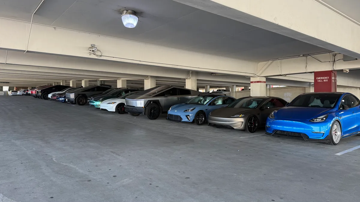 Long row of custom Tesla vehicles including multiple Cybertrucks at the SoCal TeslaRuns gathering