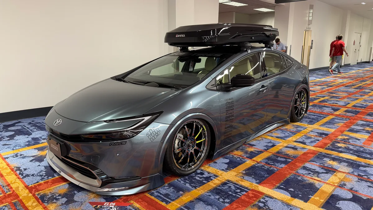 Customized dark grey Toyota Prius with Rays wheels on display at SEMA 2025