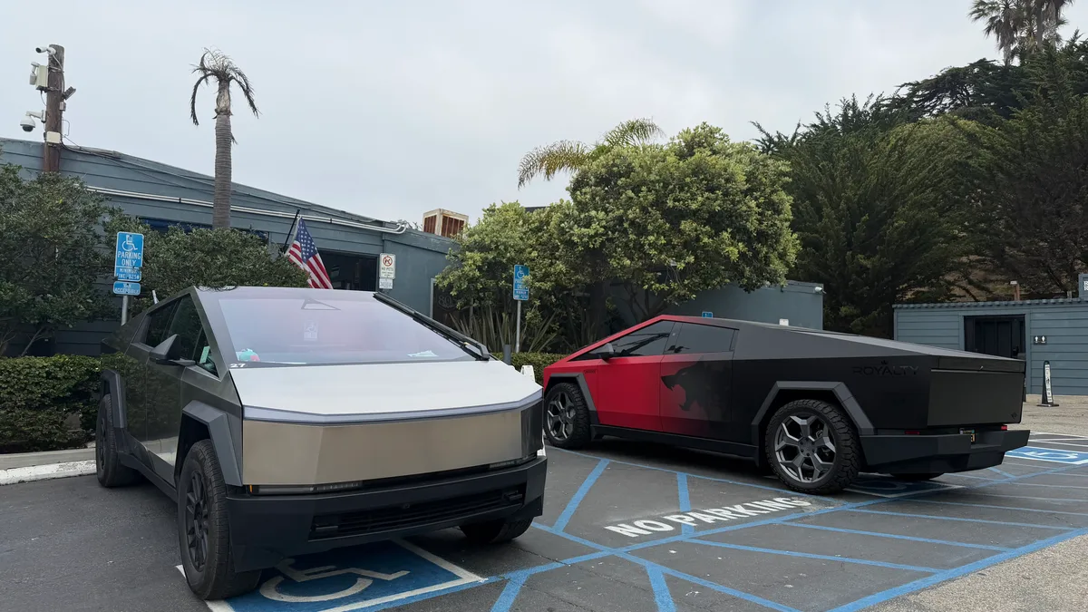 Two customized Tesla Cybertrucks parked in the Neptune's Net lot