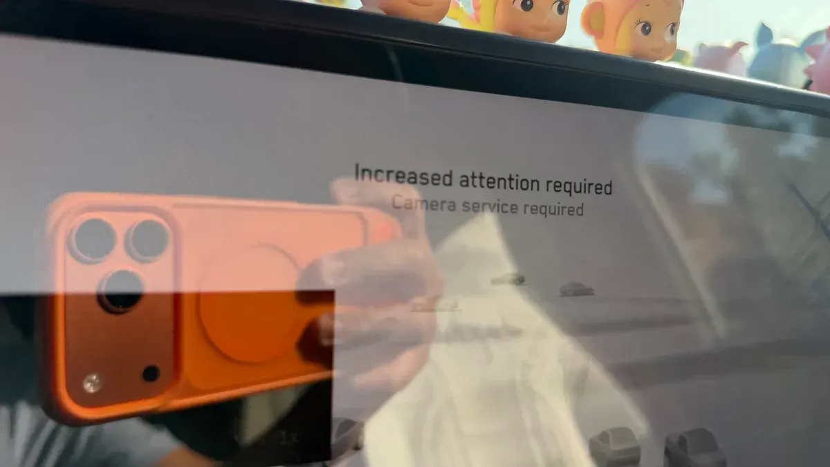Cybertruck touchscreen alert reading Increased attention required, Camera service required, at 8:53 am on the way to Tesla Service Upland.