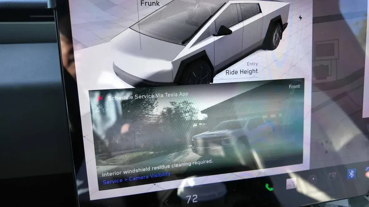 Cybertruck screen banner reading Interior windshield residue cleaning required, Service, Camera Visibility.