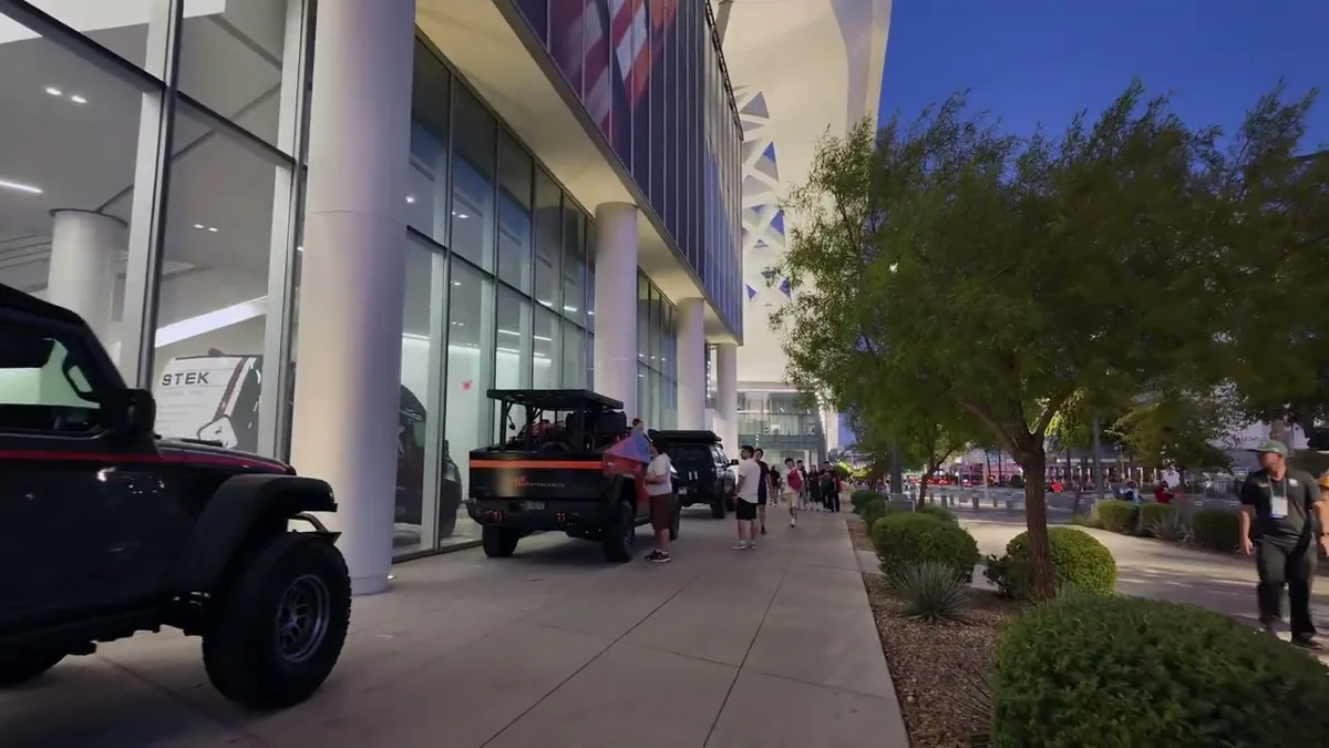 Custom trucks outside the SEMA convention center at dusk