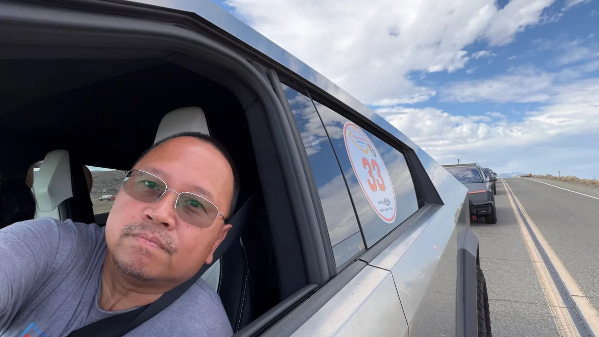 Sherwin selfie on a desert road with the Cybertruck convoy behind him during the Zero Emissions Run