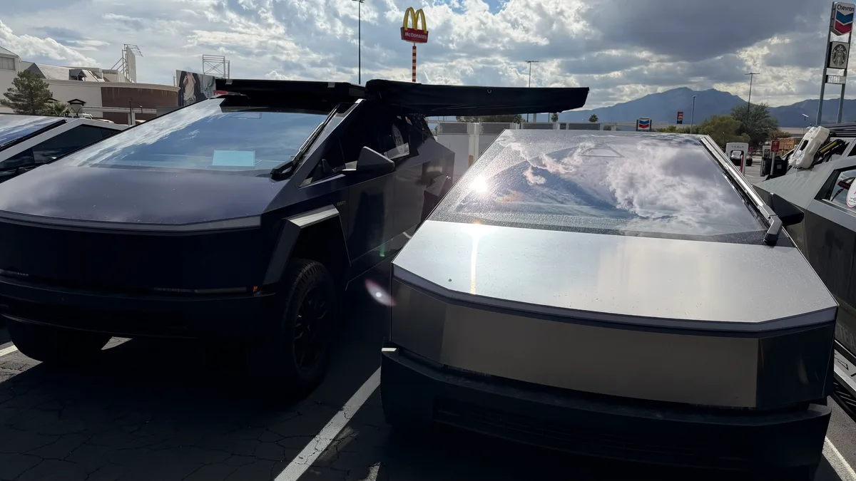 Cybertrucks with rooftop tent setup parked at a rest stop during the Zero Emissions Run Las Vegas