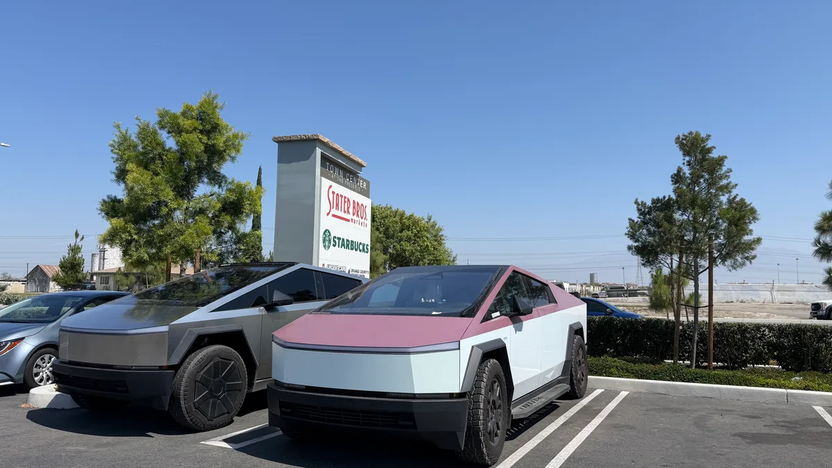 Two Cybertrucks parked together in a Stater Bros parking lot