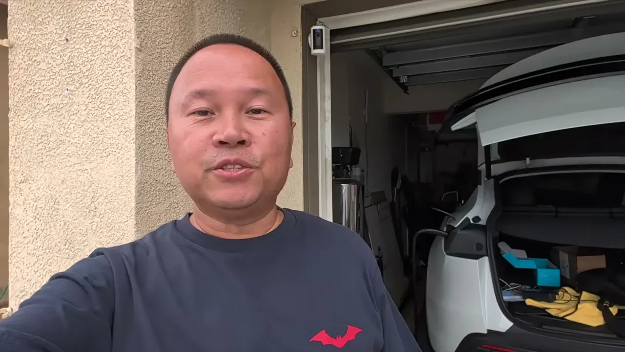 Sherwin in front of the Model Y Juniper at home with the trunk open, packing for the road trip