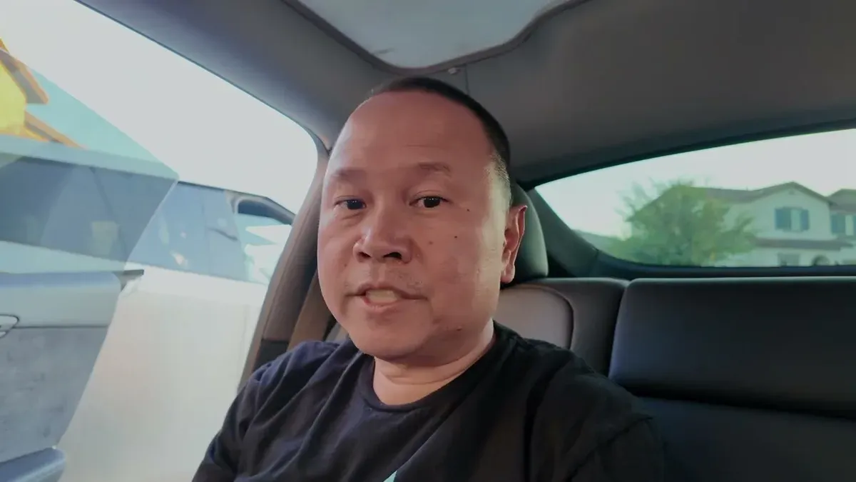 Sherwin sitting in the Model Y Juniper looking at the camera delivering the verdict