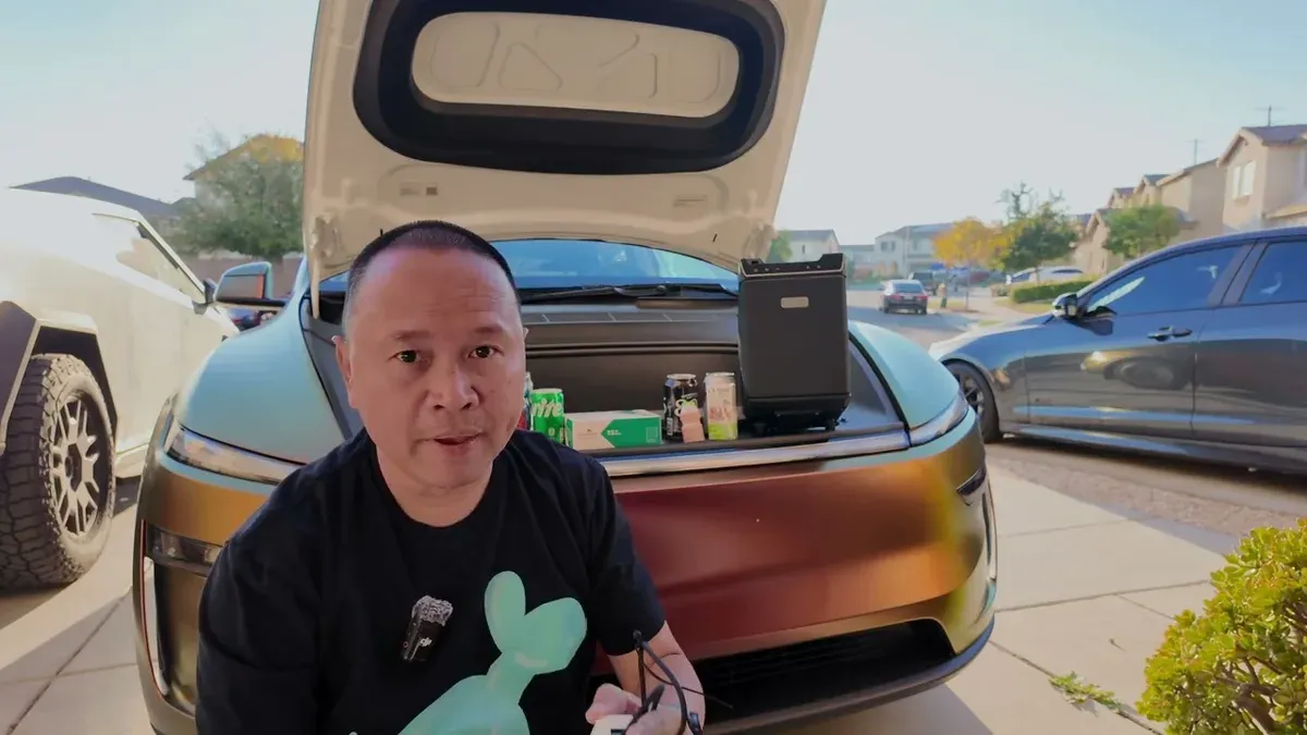 Sherwin demonstrating the open frunk with the Teslaunch fridge inside next to assorted drinks