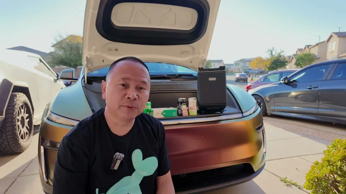 Sherwin in front of a Model Y Juniper with the frunk open showing the Teslaunch portable fridge and assorted drinks