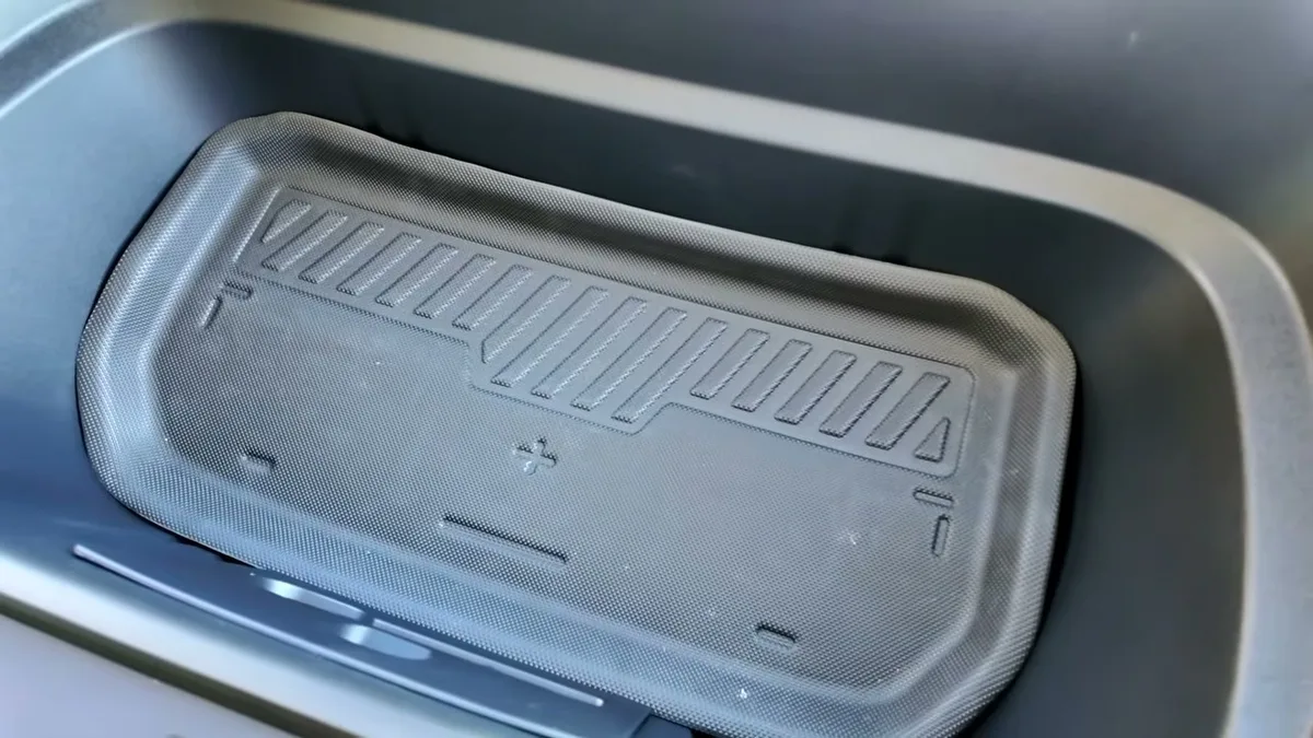 Black textured frunk liner sitting inside the Model Y Juniper frunk, not fitting perfectly on the sides
