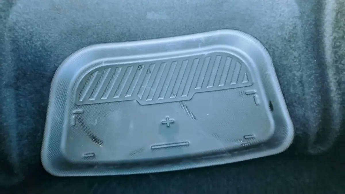 Black textured sub-trunk liner placed inside the Model Y Juniper sub-trunk area