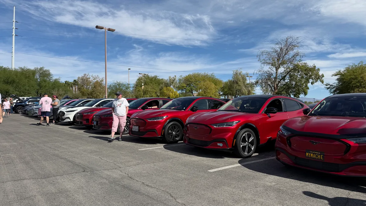Row of red Ford Mustang Mach-E SUVs lined up in a Las Vegas parking lot for the Mach-E Club meetup