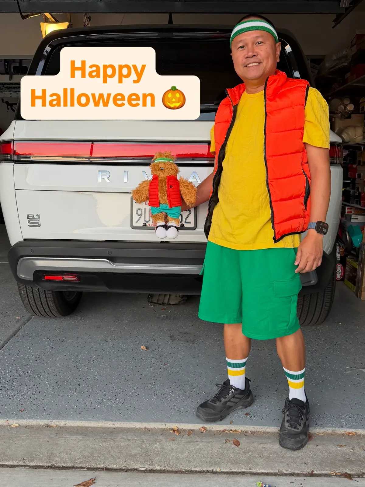 Sherwin in the Gear Guard Gary costume beside the Rivian R1S tailgate