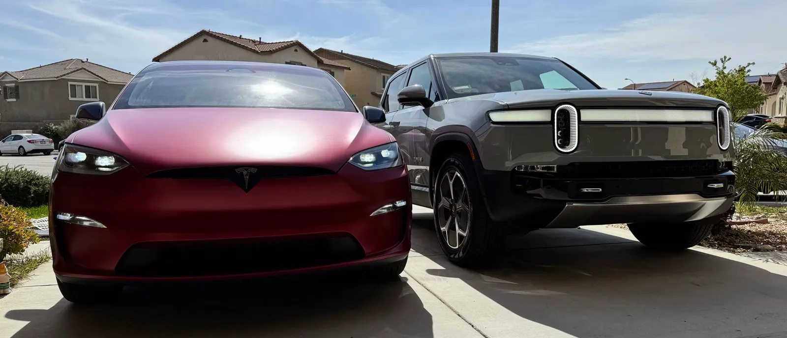 Model X next to Rivian R1T