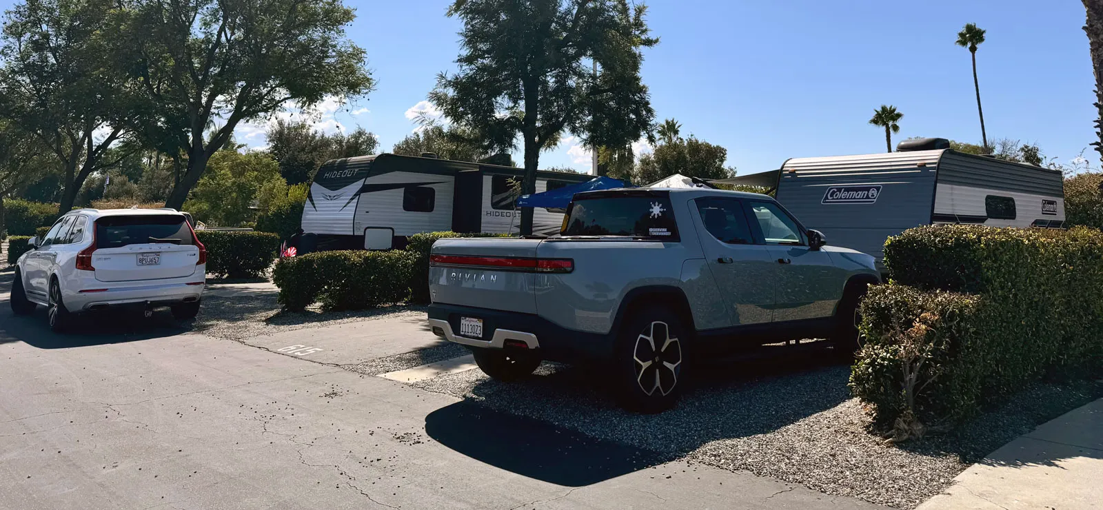Rivian R1T parked in front of camper trailer