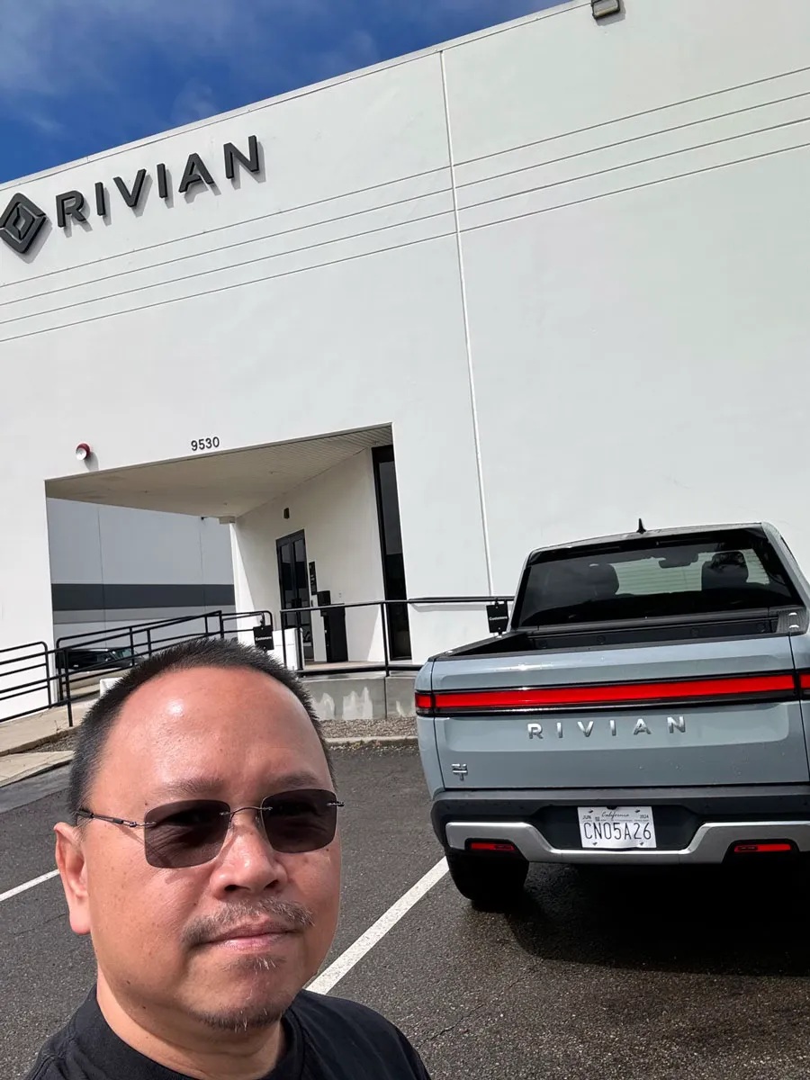 Guy standing in front of Rivian service in San Diego and R1T