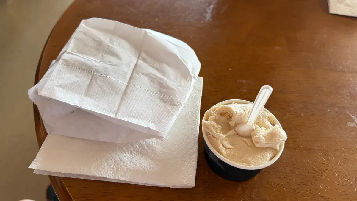Gelato cups and napkins on a wooden table