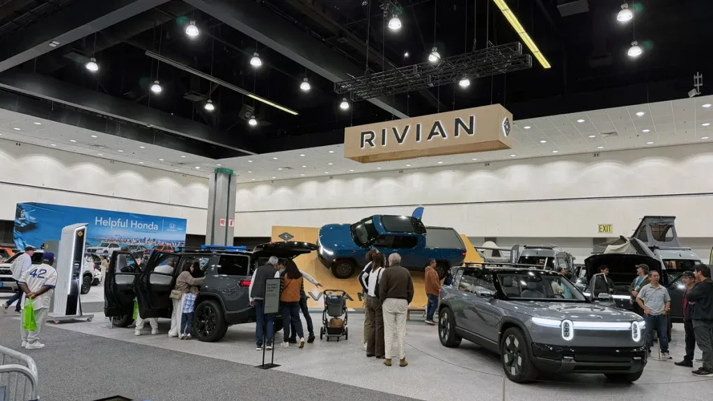 Rivian R2 on display at the LA Auto Show next to the R1S, showing size comparison