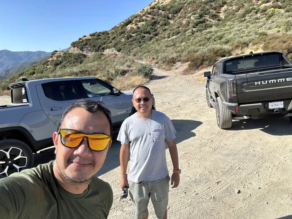 Two guys with Rivian R1T and Hummer EV