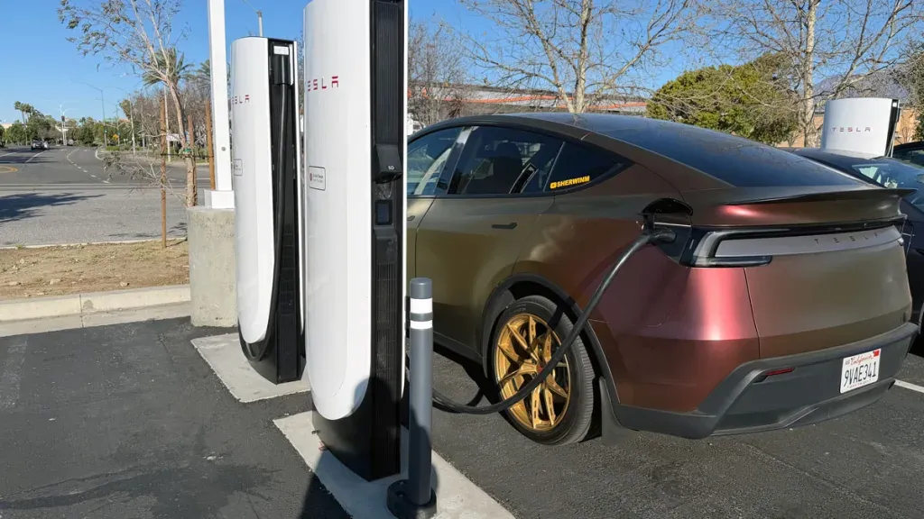Tesla Model Y Juniper charging at a Supercharger station