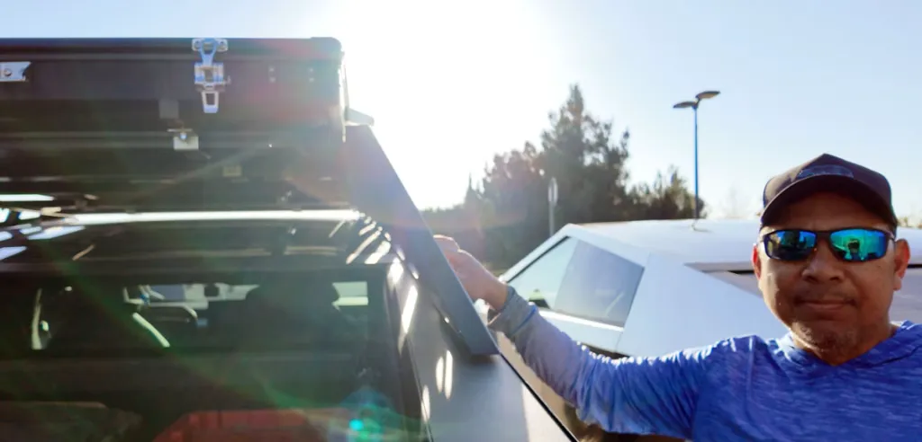Guy standing next to Cybertruck