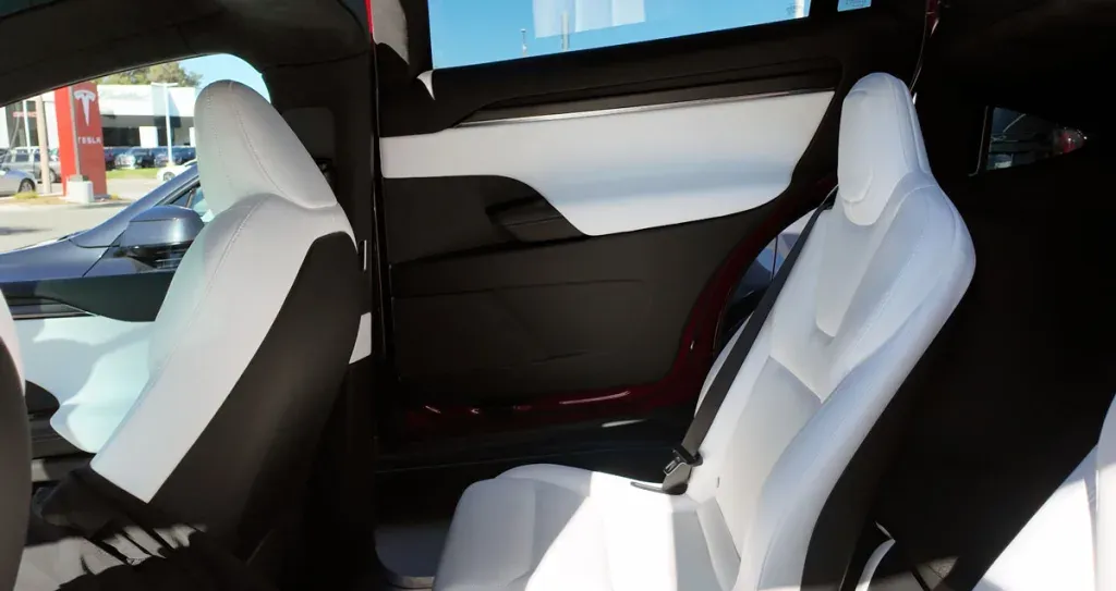 2026 Tesla Model X Plaid white interior with yoke steering wheel and captain's chairs six-seat configuration