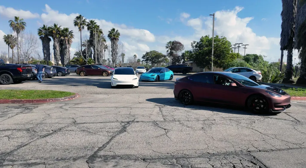 Tesla vehicles leaving a parking lot