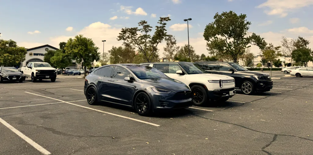 Model X and Rivian R1S at a parking lot