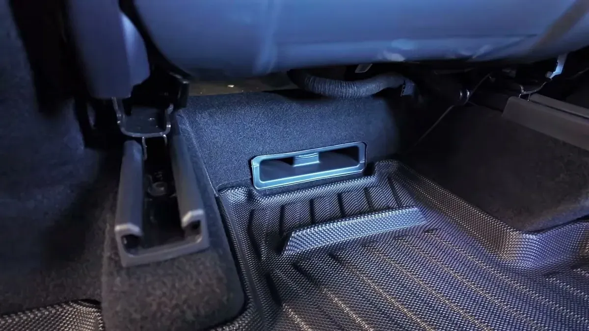 Jowua under-seat vent cover installed on Tesla Model Y Juniper rear floor.