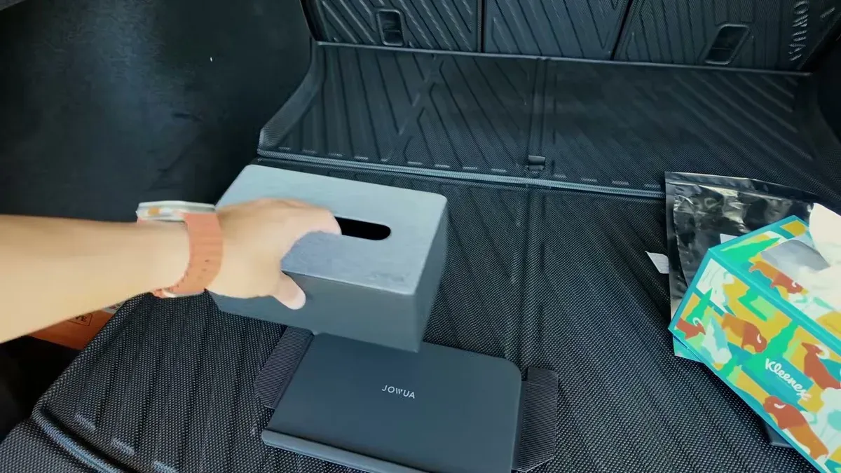 Jowua silver tissue box holder placed on second-row floor mat in Tesla Model Y.