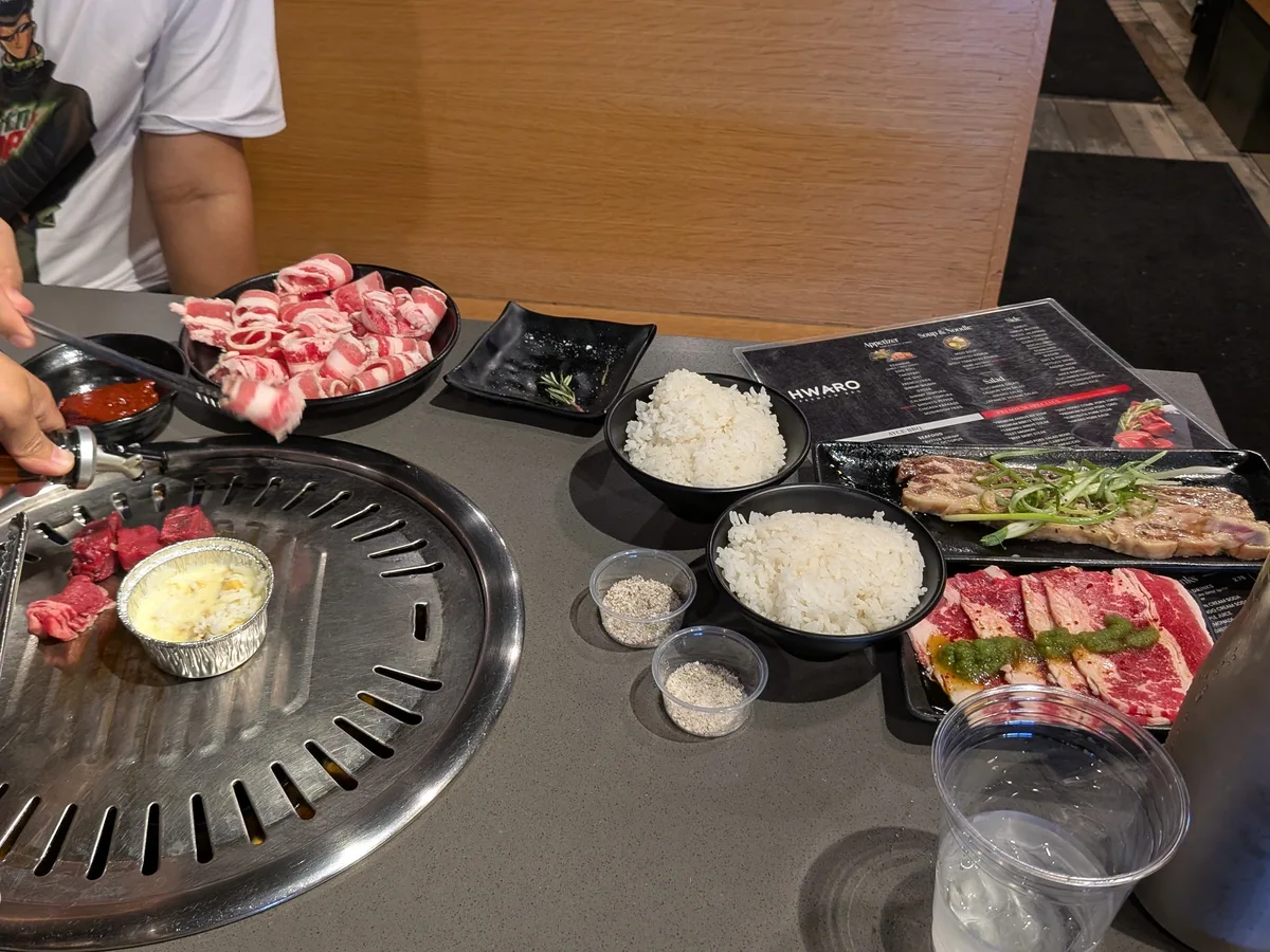 Korean BBQ table with raw meats ready for grilling