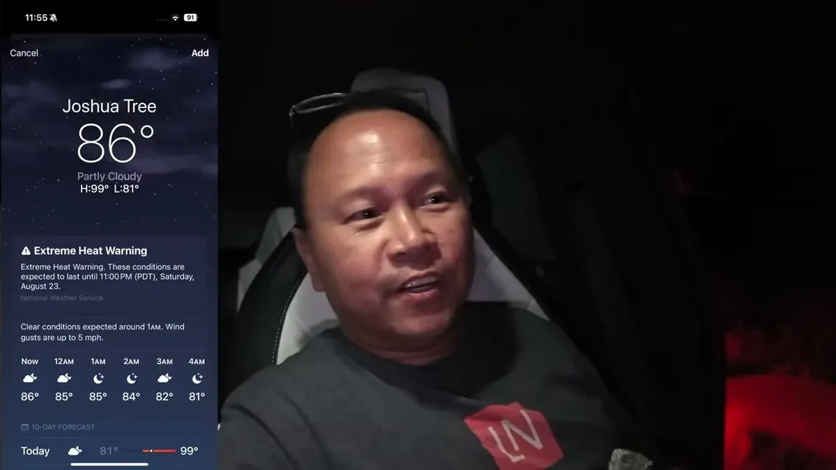 Man in car at night with Joshua Tree weather app showing 86°F and extreme heat warning