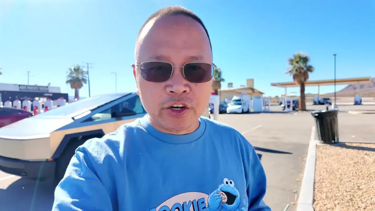 Man in Cookie Monster shirt, Cybertruck and Supercharger in background at Yermo.