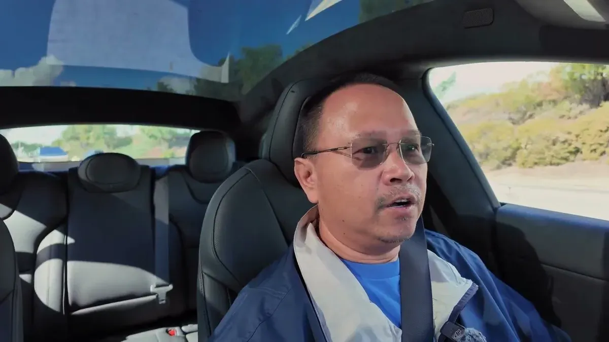 Man with glasses driving the 2026 Tesla Model S on a SoCal road during first drive impressions.