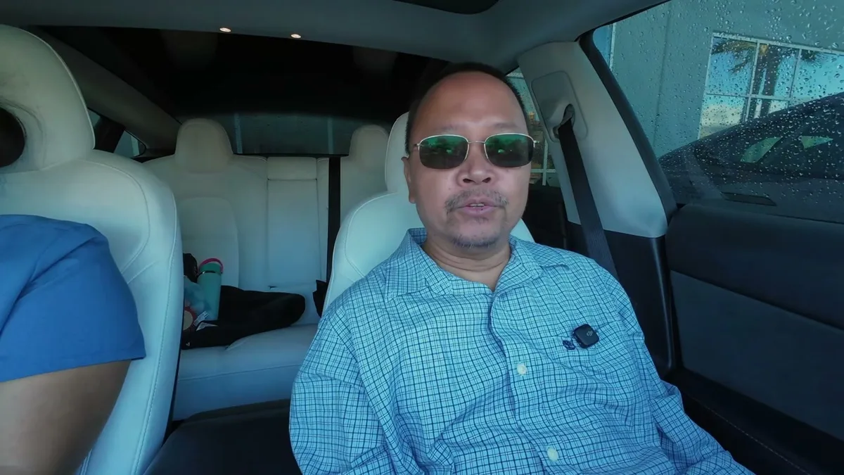 Man in green sunglasses in loaner Model 3 at Upland Tesla service center