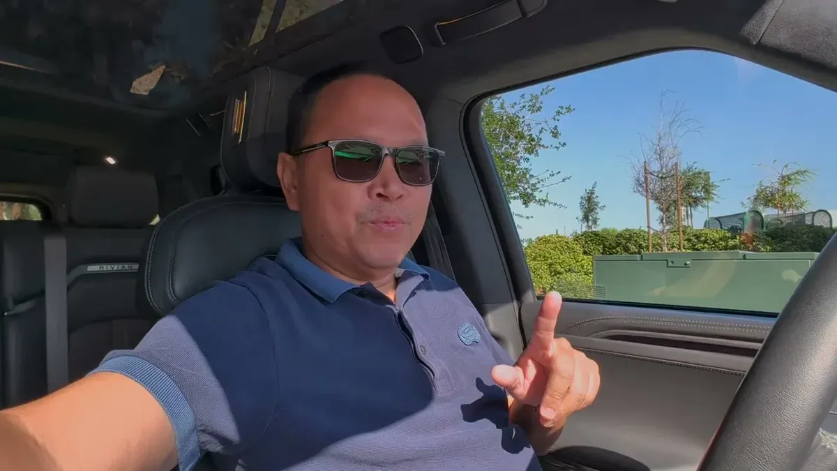 Sherwin gesturing while talking about the Gen 1 loaner inside the Rivian R1S