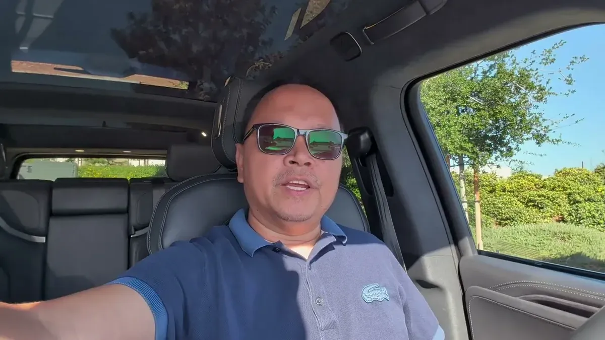 Sherwin in the driver's seat of the Gen 1 R1S loaner with panoramic glass roof visible
