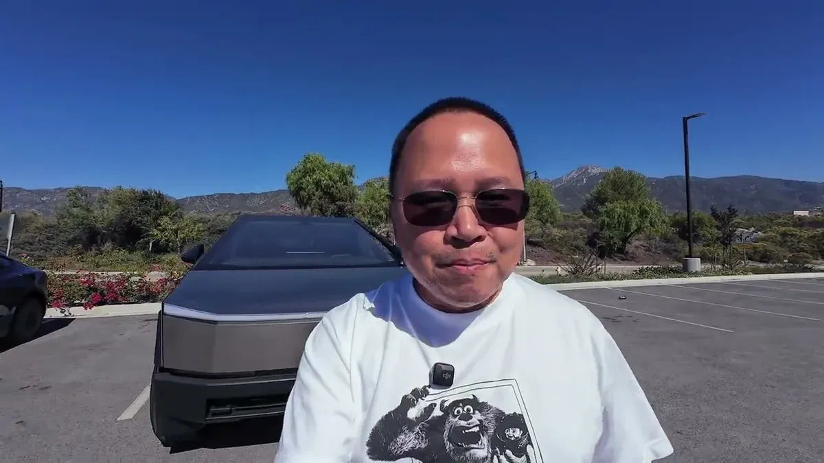 Sherwin standing in front of both the Model 3 Standard and Cybertruck in a sunny parking lot