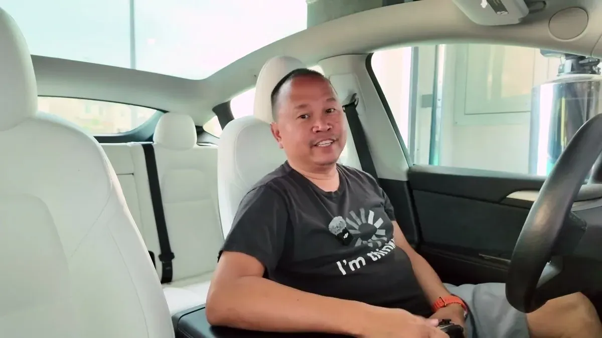 Sherwin smiling in the Model Y at the end of the gaming session