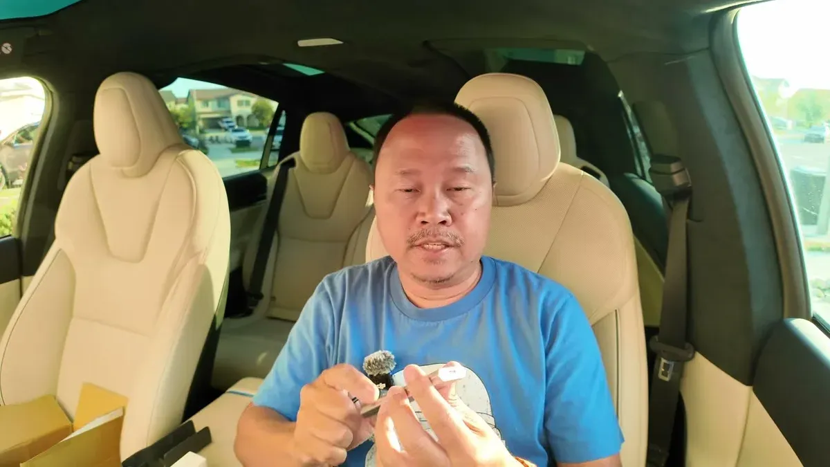 Sherwin in the Model X Plaid demonstrating Jowua gaming accessories