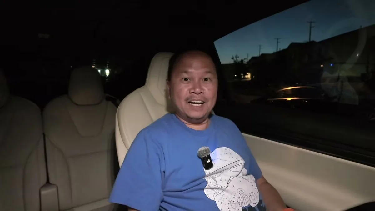 Sherwin at night in the Model X with a big smile after gaming for too long
